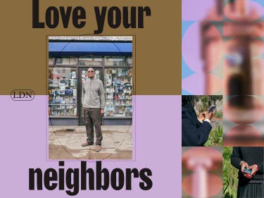 A man with sunglasses on standing in front of a local store with the label ‘love your neighbors’.