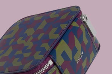 A close up detailed view of the new geometric print pattern of the Away Jewelry Box and other travel accessories