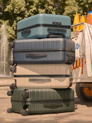 Carry-on sizes of Away suitcases in various colors stacked on top of each other in Mexico City.