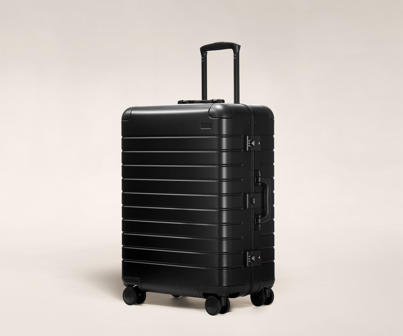 Aluminum checked luggage The Medium suitcase in Onyx Black with raised handle