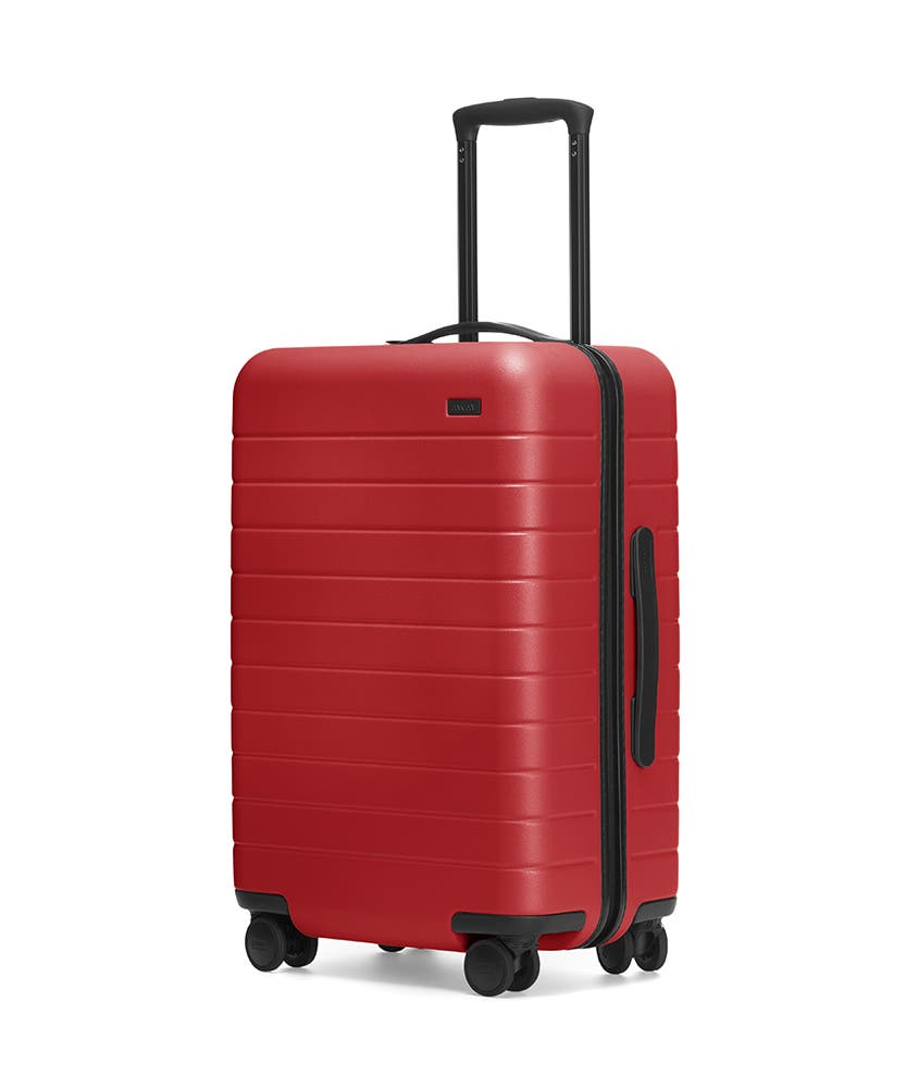 Red hardside Bigger Carry-On with raised telescopic handles shown at an angle.