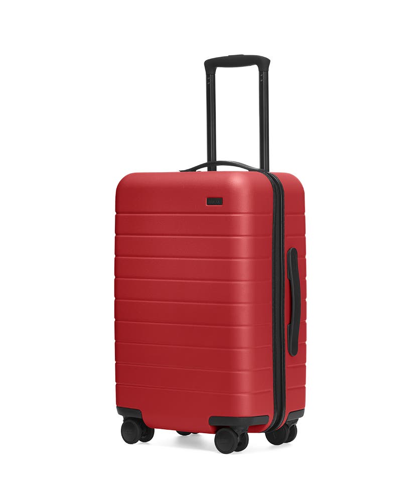 Red hardside Carry-On with raised telescopic handles shown at an angle.