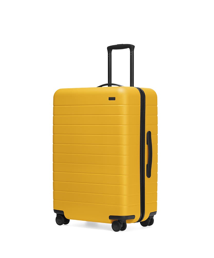 The Canary Medium hardside with raised telescopic handles shown at an angle.