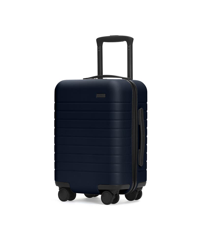 The Kids’ Carry-On in Navy shown at an angle with raised telescoping handle