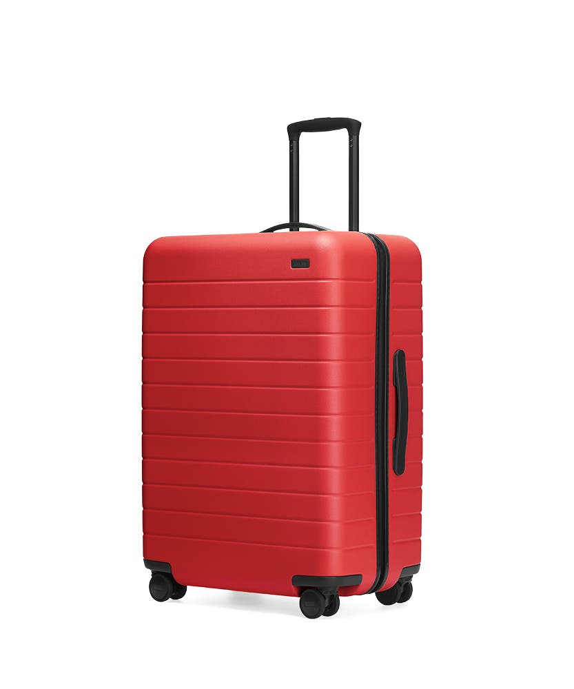 The Cherry Medium hardside with raised telescopic handles shown at an angle.
