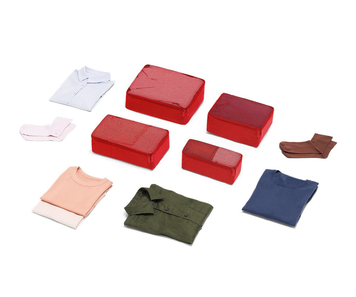 Set of four packing cubes in Cherry with clothes displayed around it