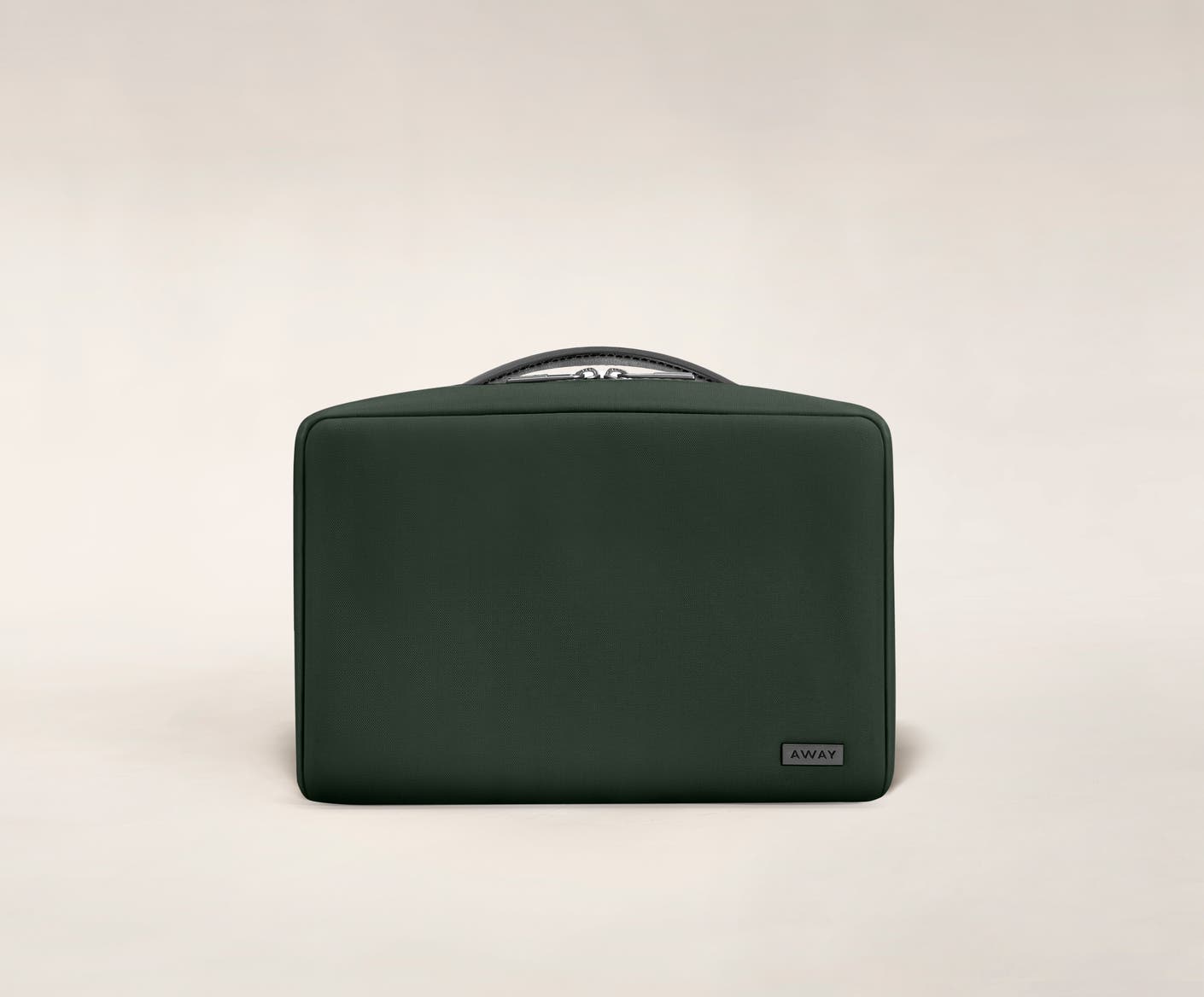 Small travel toiletry bag in the color green by Away.