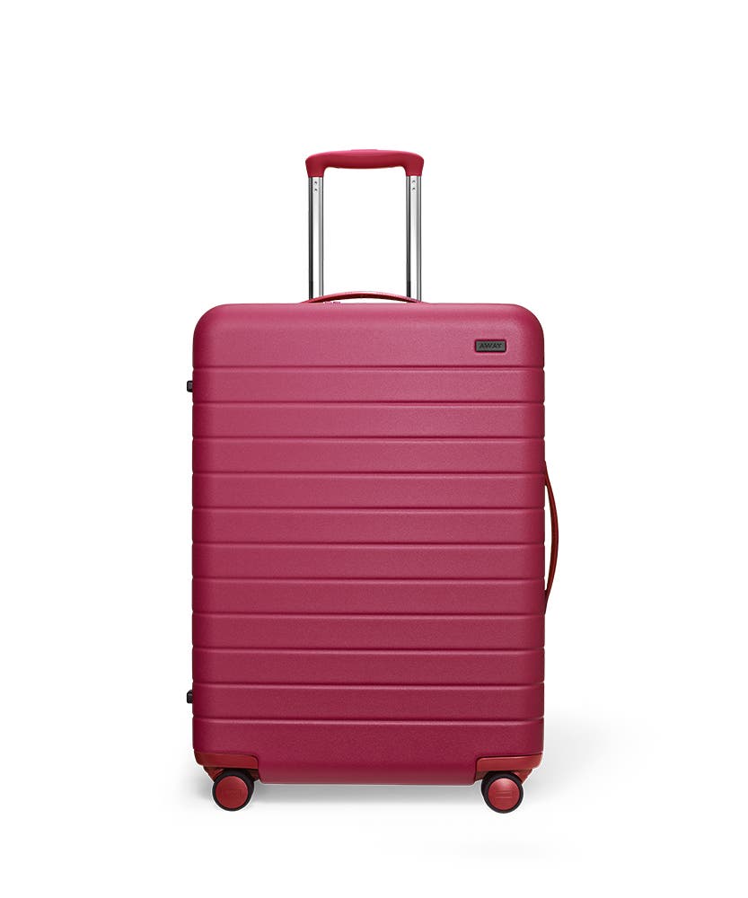 Front view of the Away Medium Plum Matte hardside showing raised handle.