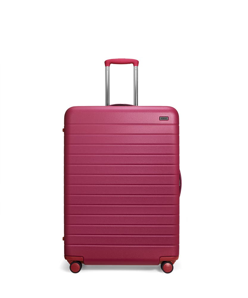 Front view of the Away Large Plum Matte hardside showing raised handle.