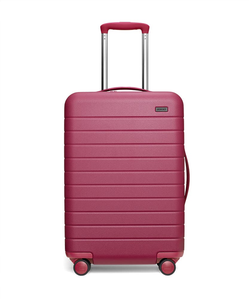 Front view of the Away Bigger Carry-On Plum Matte hardside showing raised handle.