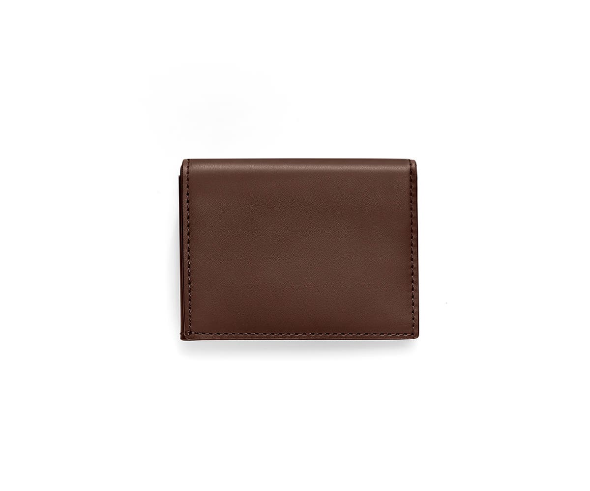 A chestnut L-Fold wallet for travel.