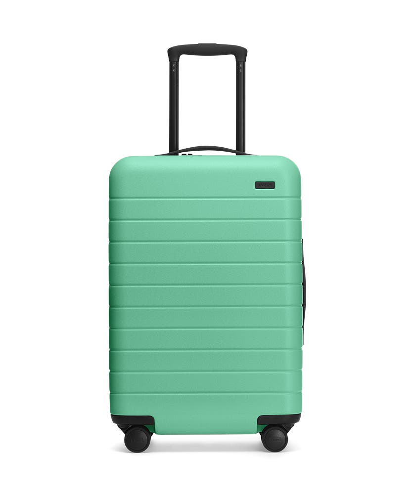 Front view of the Away Aqua Bigger Carry-On hardside showing raised handle.