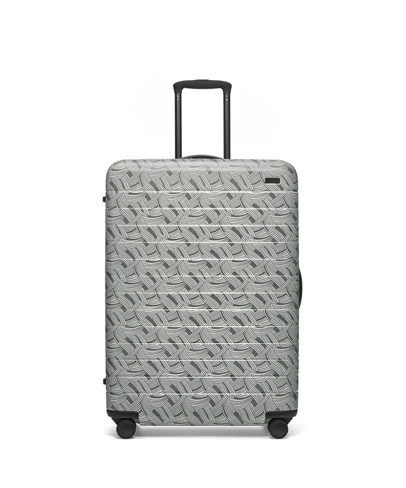 Front view of the Away Light Swirl Large hardside showing raised handle.