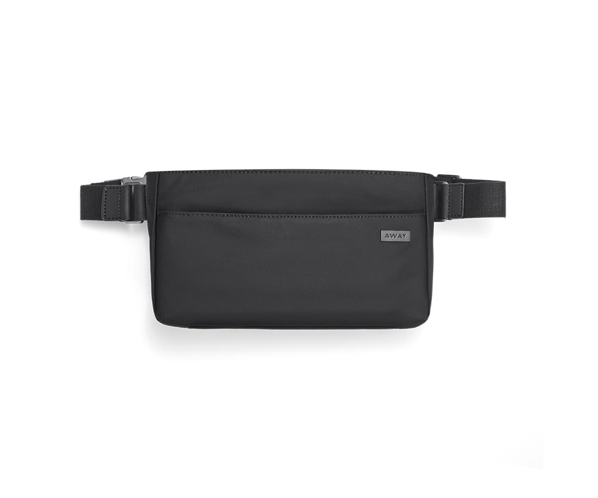 A front view of a sling bag with a front pocket in black.