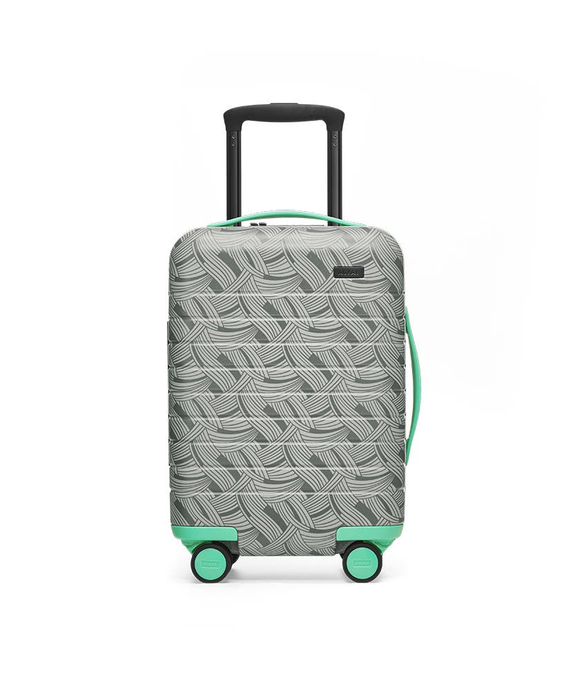 Front view of the Away Kids' Carry On Light Swirl hardside showing raised handle.