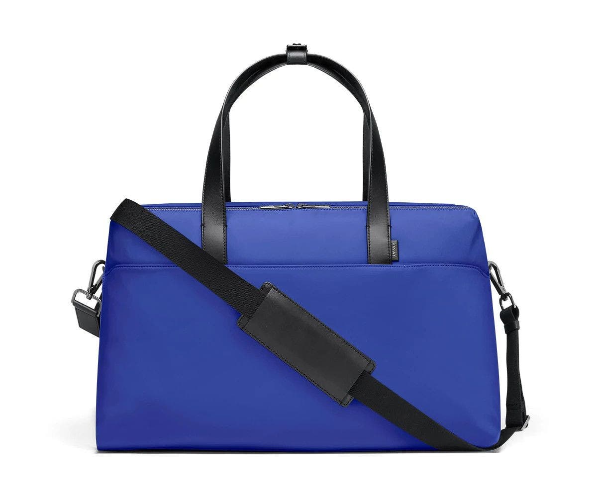 Large shoulder bag in cobalt with raised handles and shoulder strap across the bag.