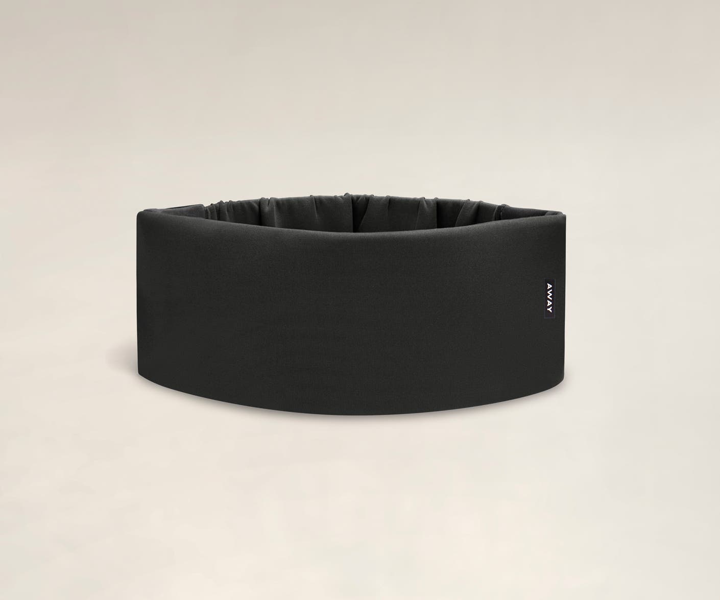 A cushioned black travel sleep mask by Away.