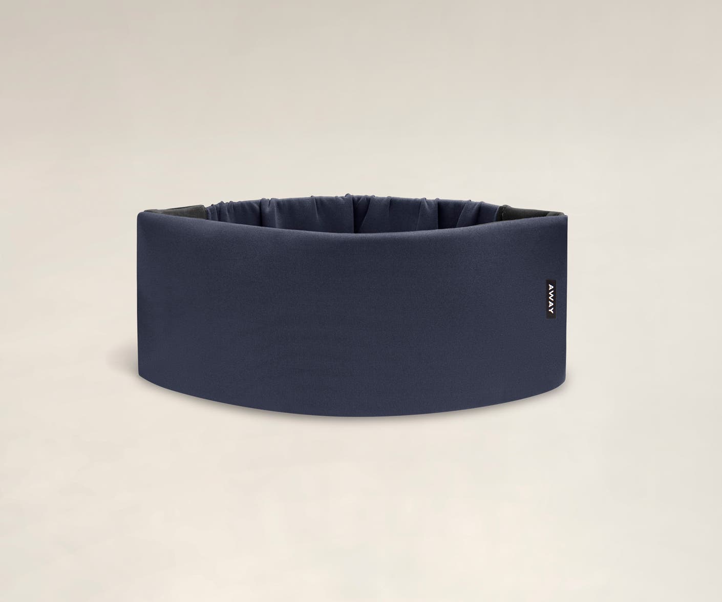 A cushioned navy blue travel sleep mask by Away.