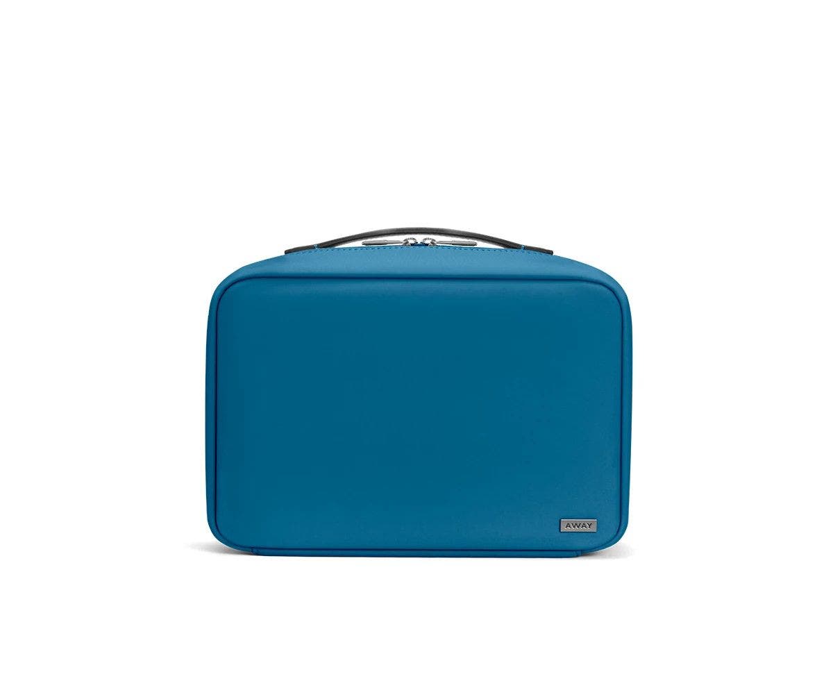 Front view of a deep teal toiletry bag with handle on top.