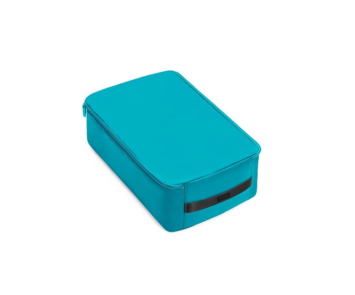 A large bright teal shoe cube