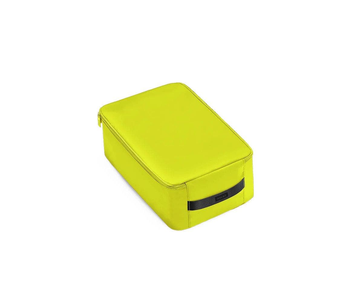 A angled view of a small lime green shoe cube.