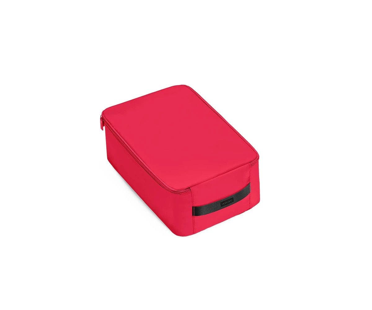 A angled view of a small electric magenta shoe cube.