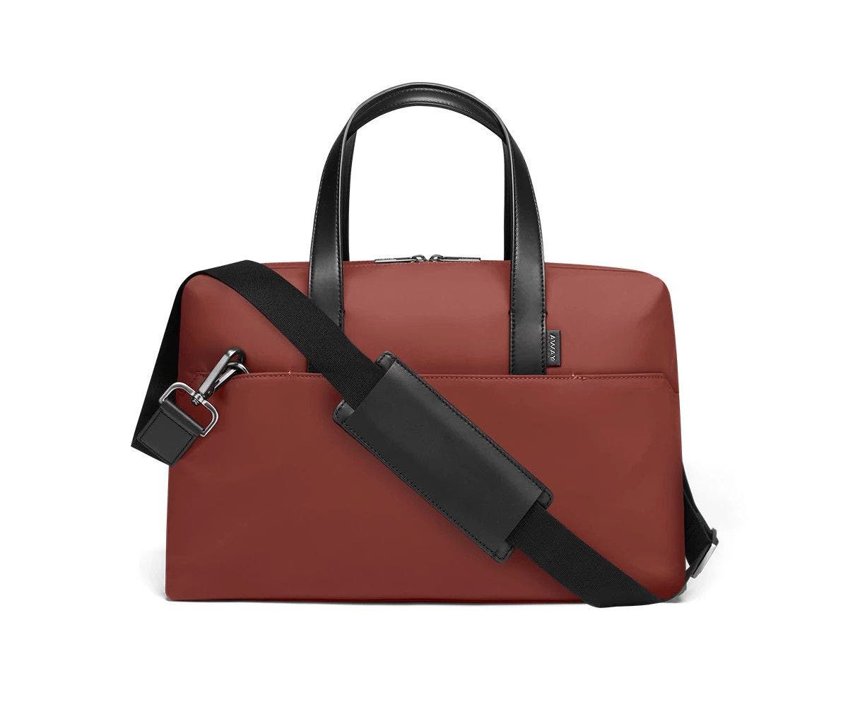 Brick duffle with back zip pocket, and shoulder strap across the bag.