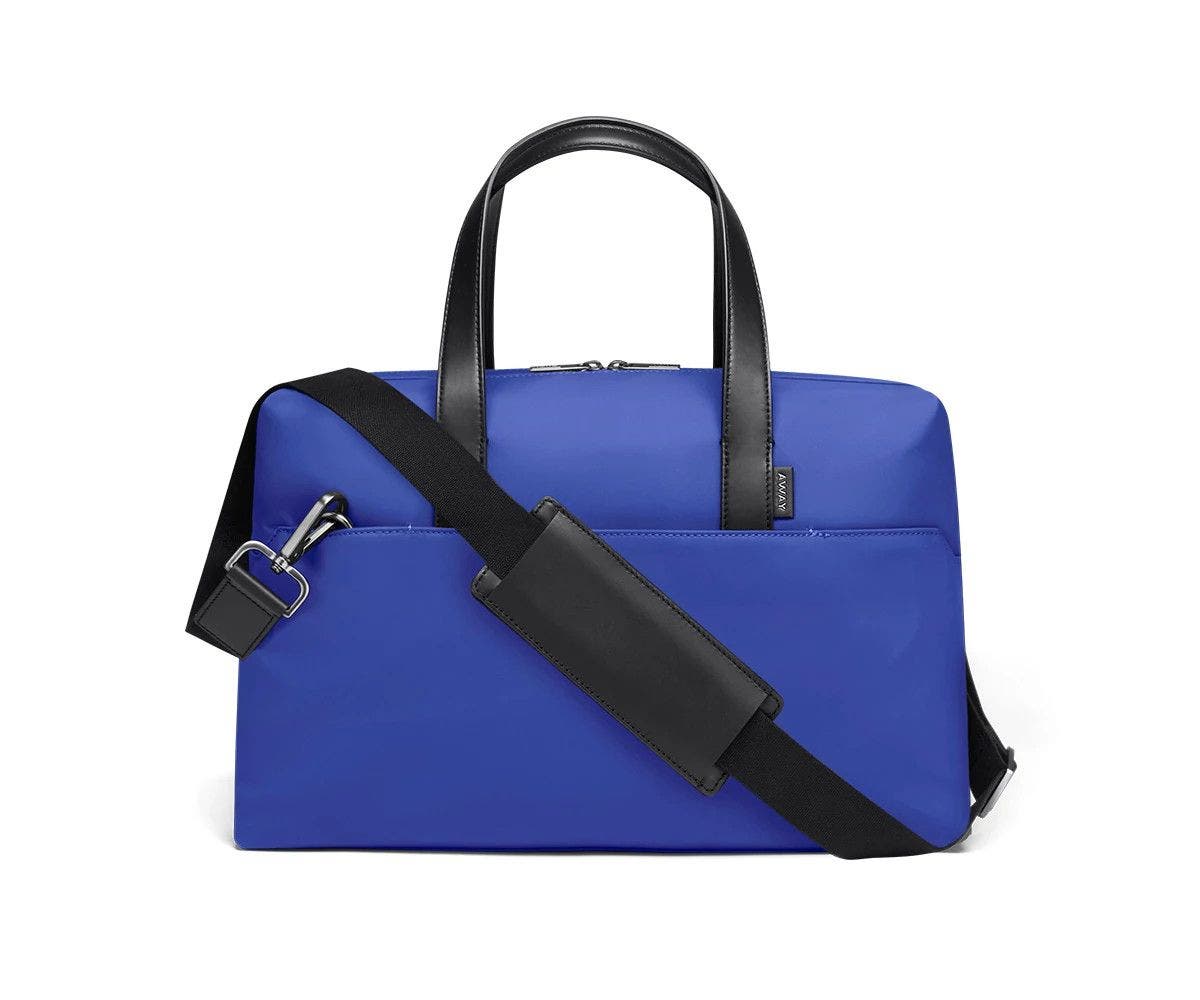 Cobalt duffle with back zip pocket, and shoulder strap across the bag.