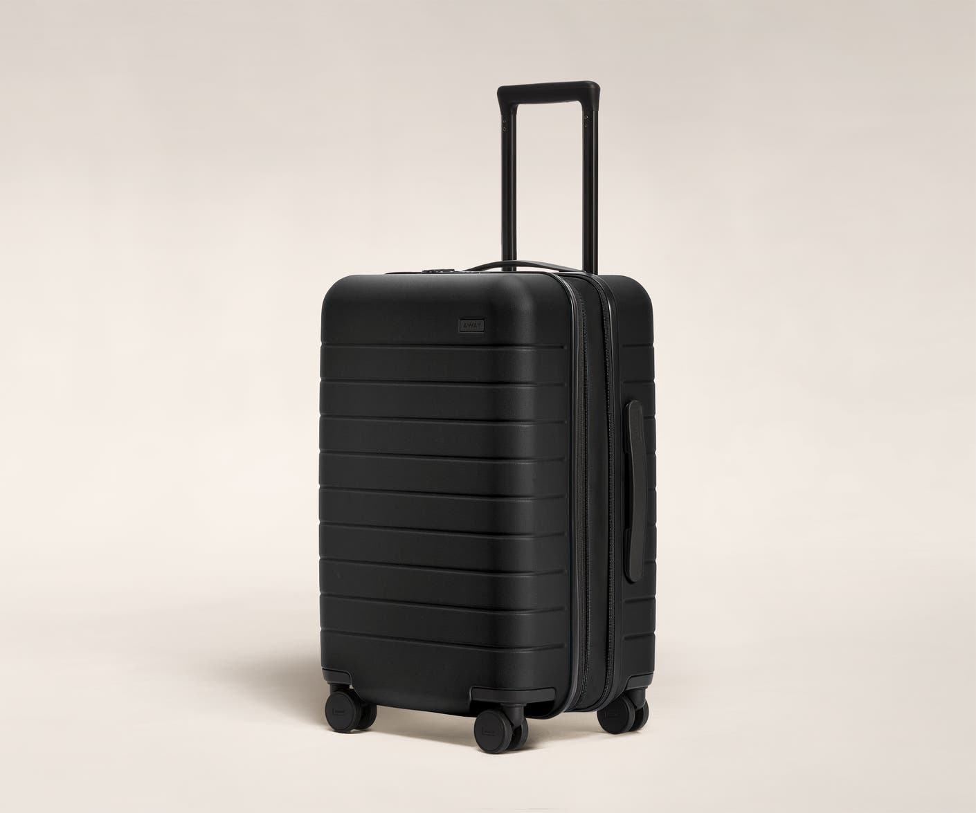 The Carry-On Flex in Black shown at an angle with raised telescoping handle.