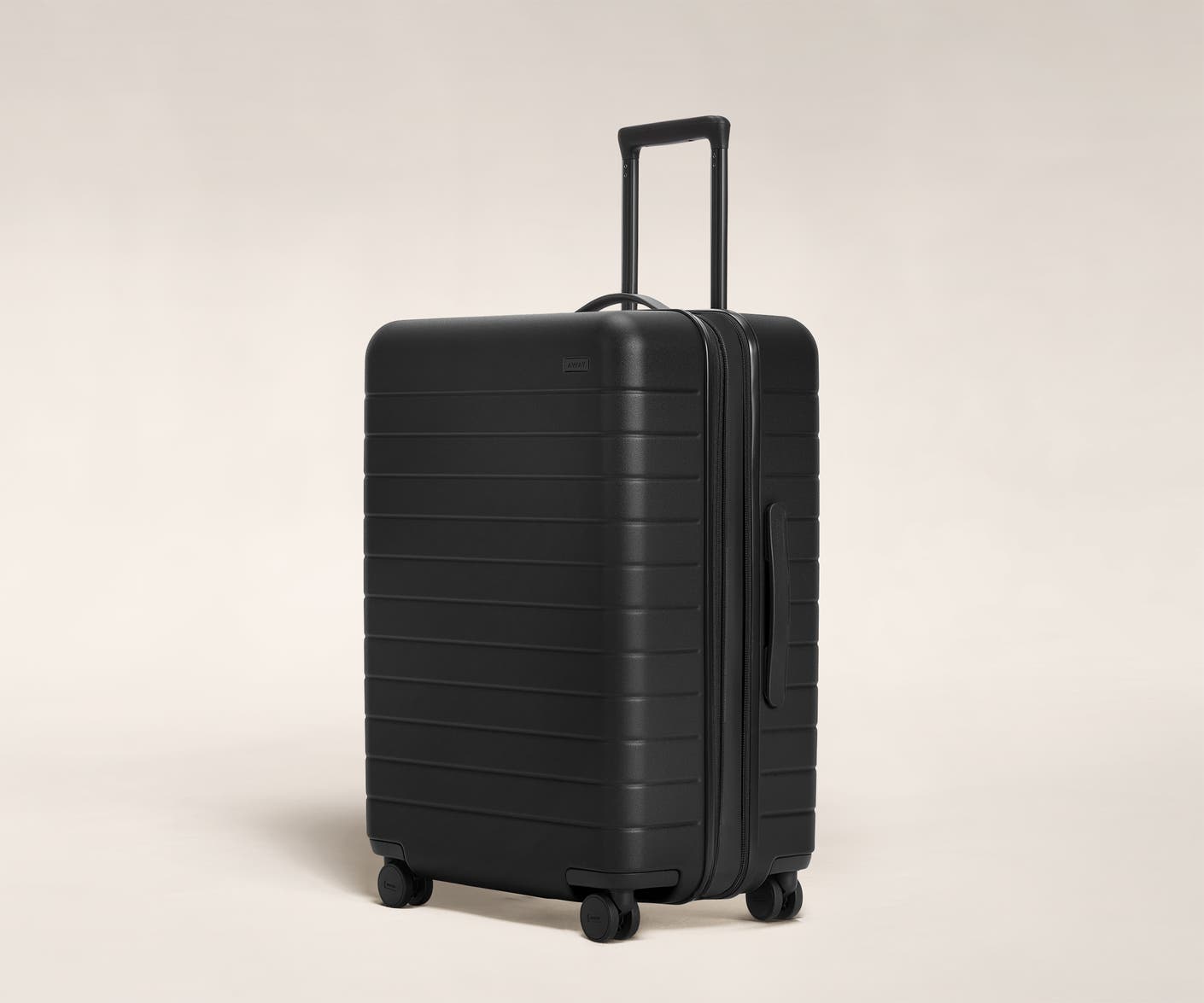 The Medium Flex in Black shown at an angle with raised telescoping handle.