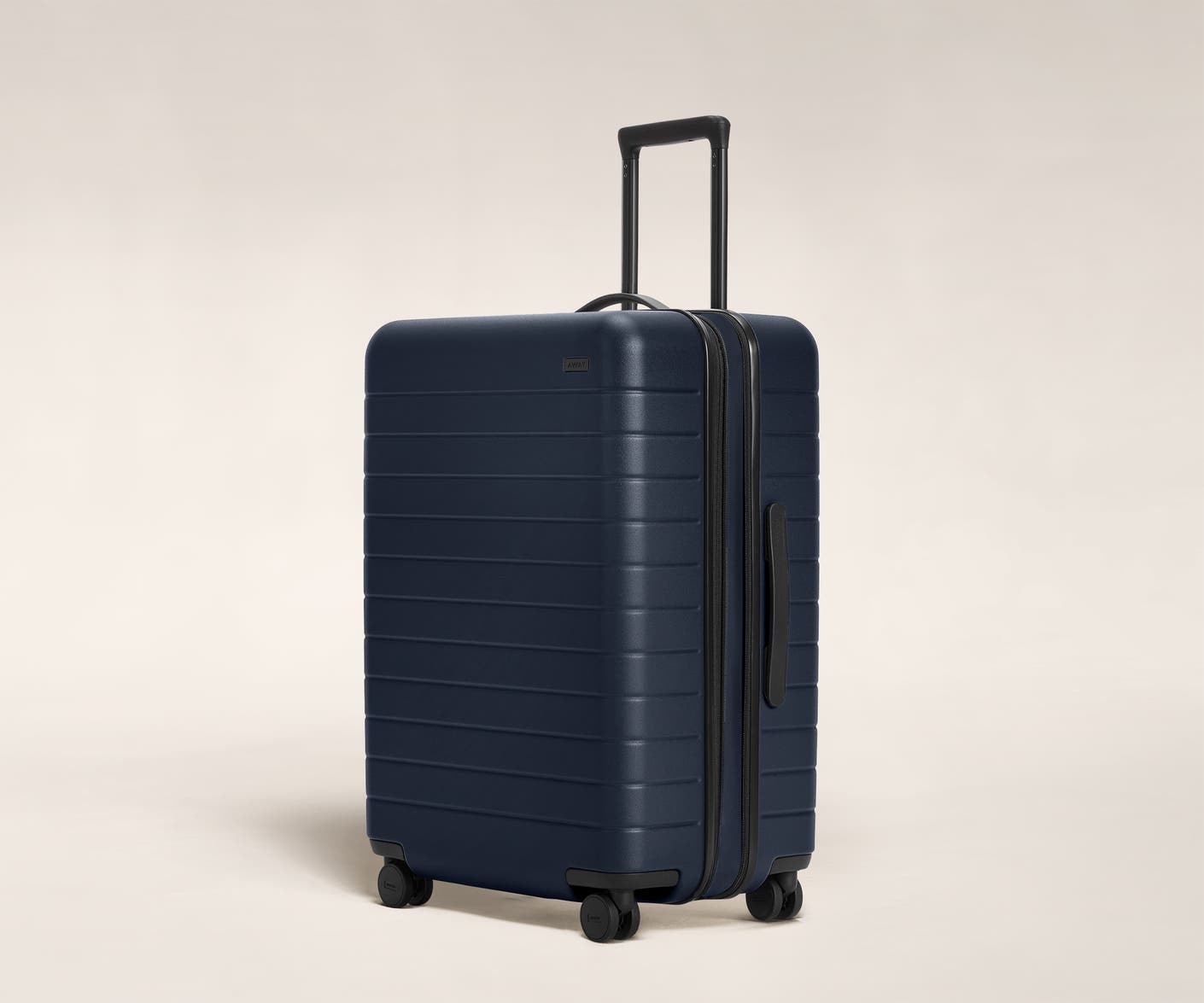 The Medium Flex in Navy shown at an angle with raised telescoping handle.