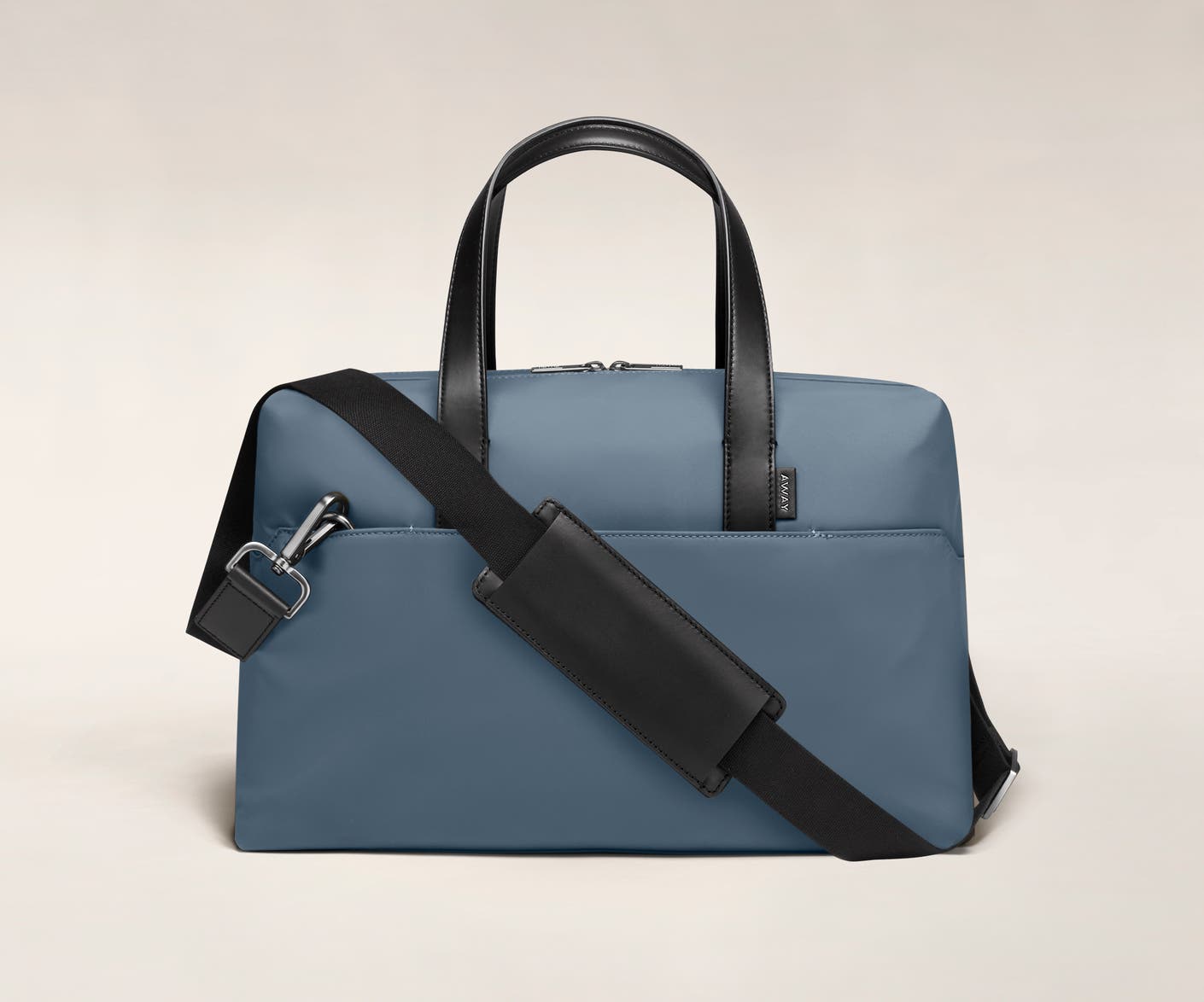 Coast duffle with back zip pocket, and shoulder strap across the bag.