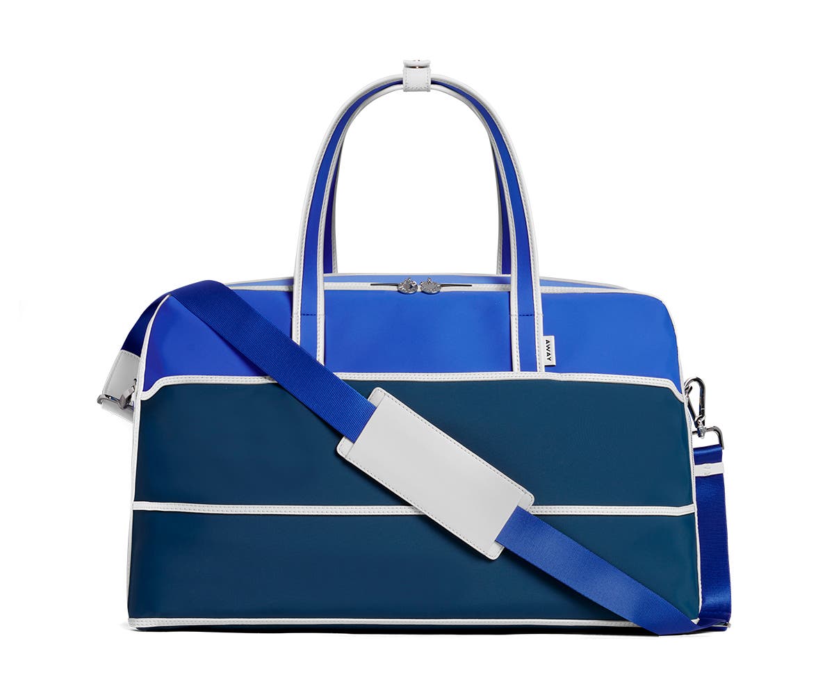 The Large Everywhere Bag by Ji Won Choi in blue geometric patterns and a shoulder strap