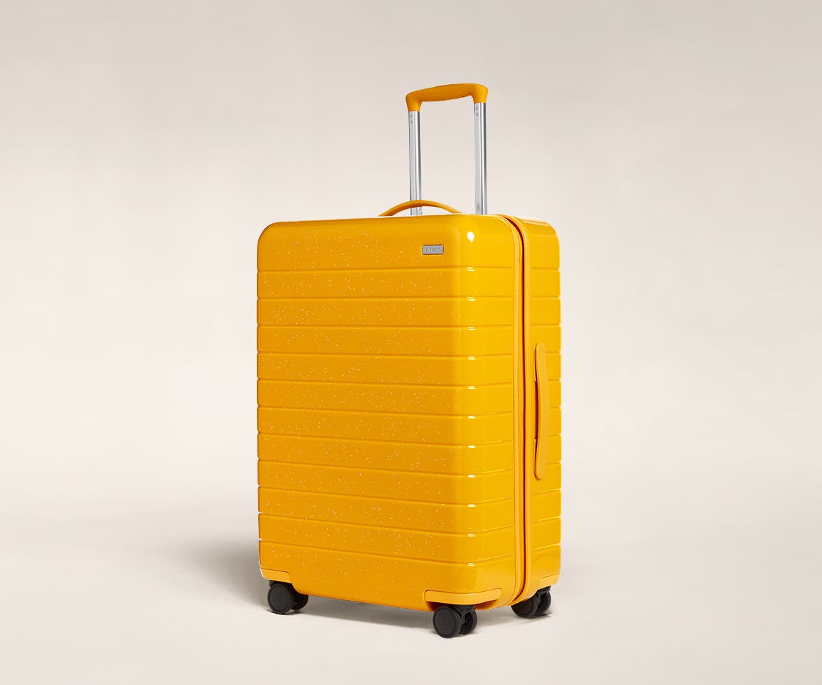 A saffron sparkle Medium with raised telescopic handles shown at an angle.