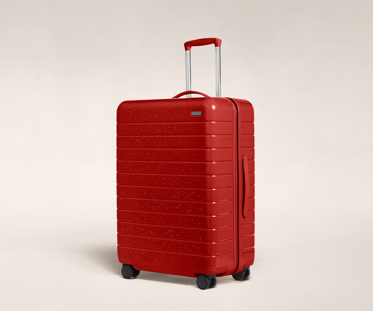 A cranberry sparkle Medium with raised telescopic handles shown at an angle.