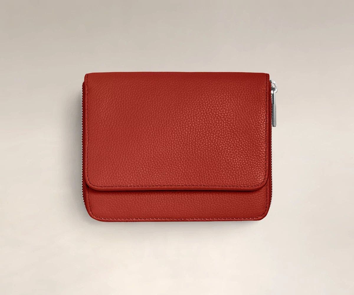 Front, closed view of the Away Jewelry Sleeve in cranberry red leather