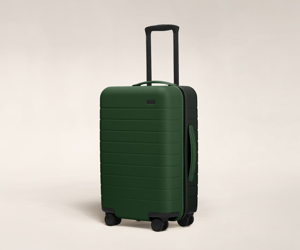 Pine/Green Carry-On with raised telescopic handles shown at an angle.