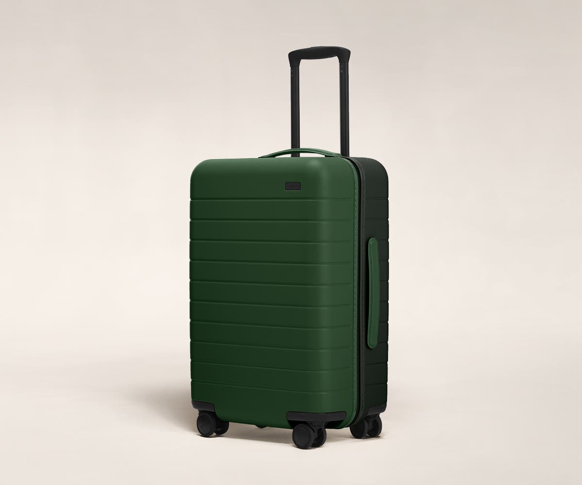 Pine/Green Bigger Carry-On with raised telescopic handles shown at an angle.