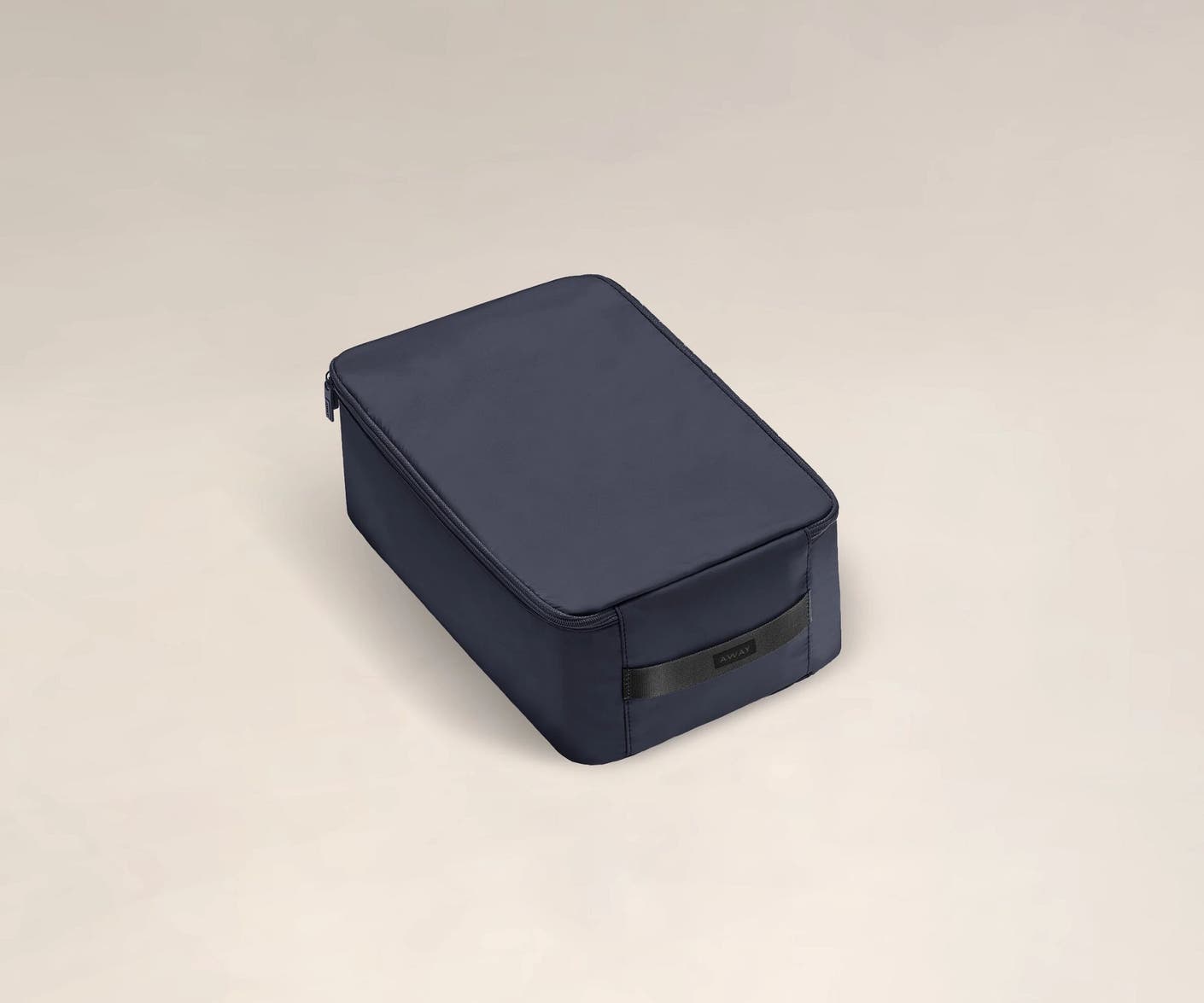 A angled view of a small black shoe cube.