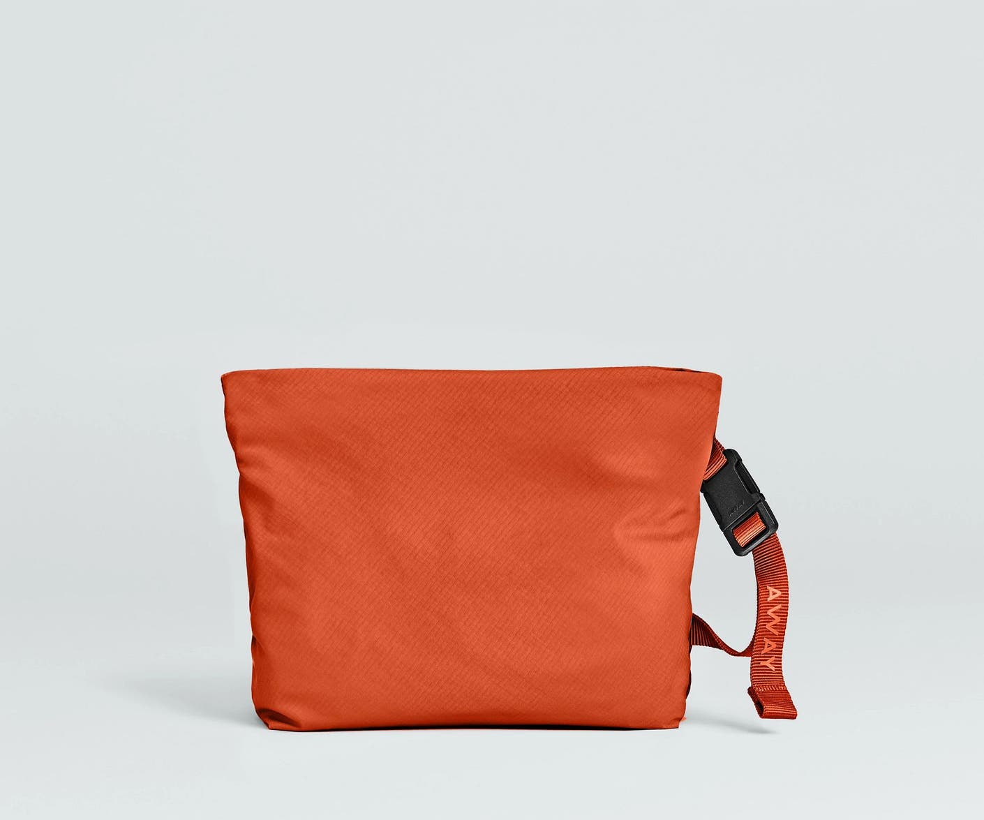 Front view of the Away For All Routes Small Pouch in red orange