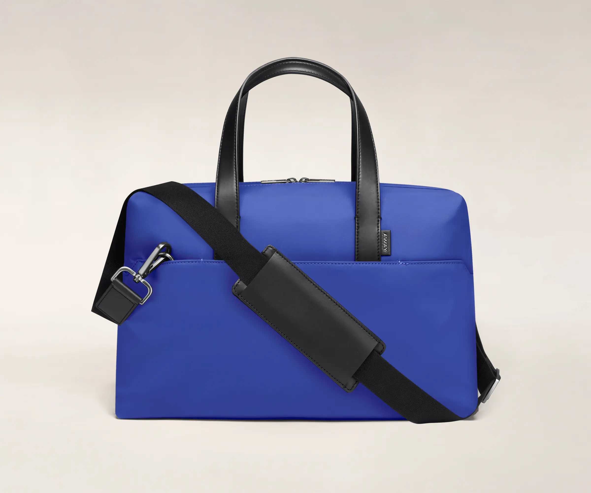Cobalt duffle with back zip pocket, and shoulder strap across the bag.