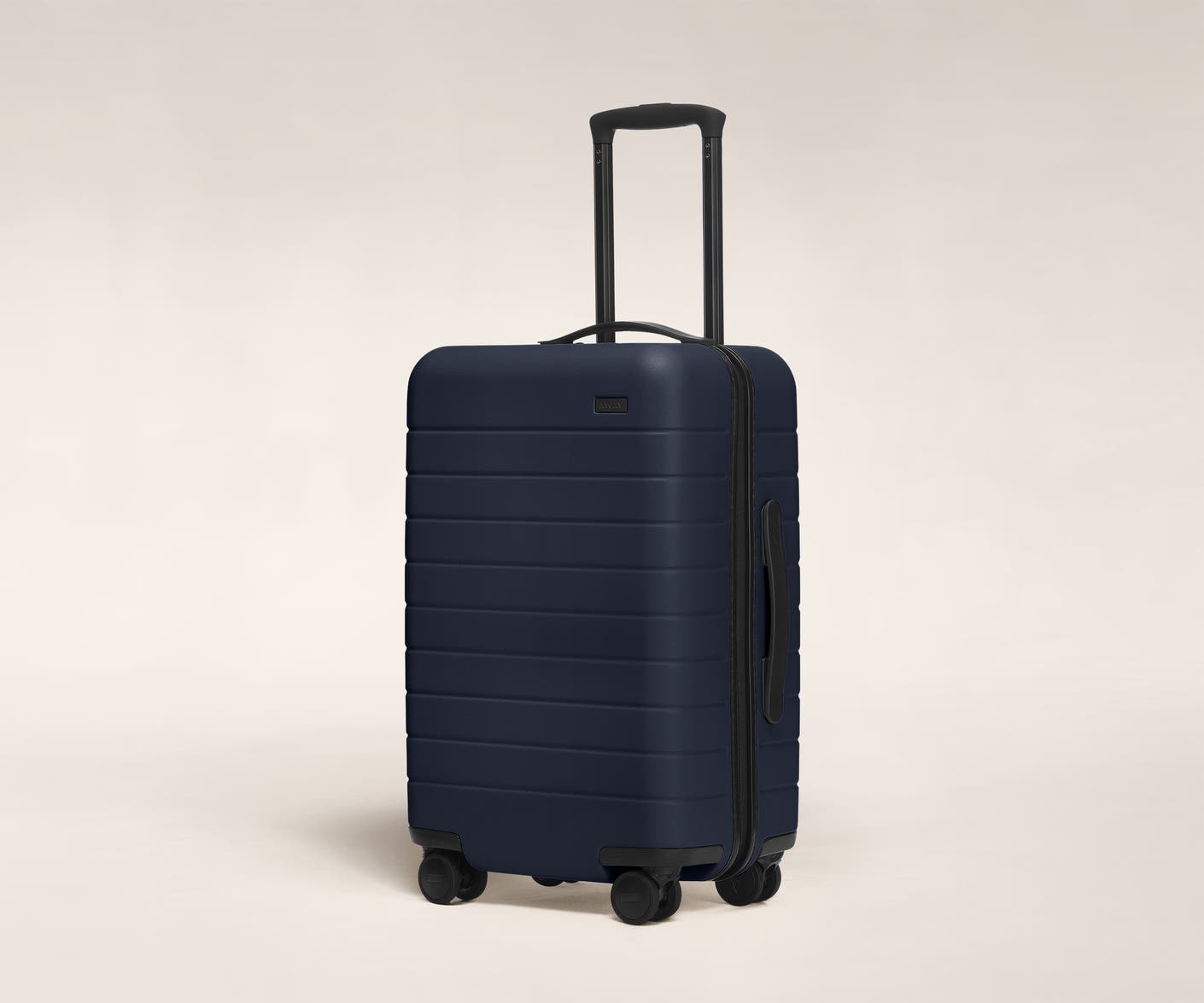 The Carry-On in Navy shown at an angle with raised telescoping handle
