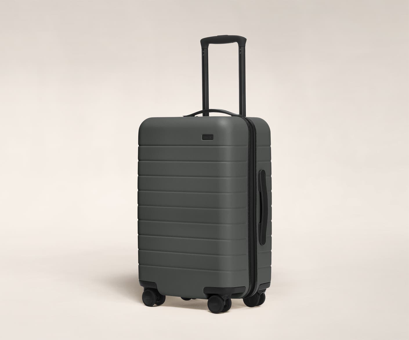 The Carry-On in Asphalt shown at an angle with raised telescoping handle