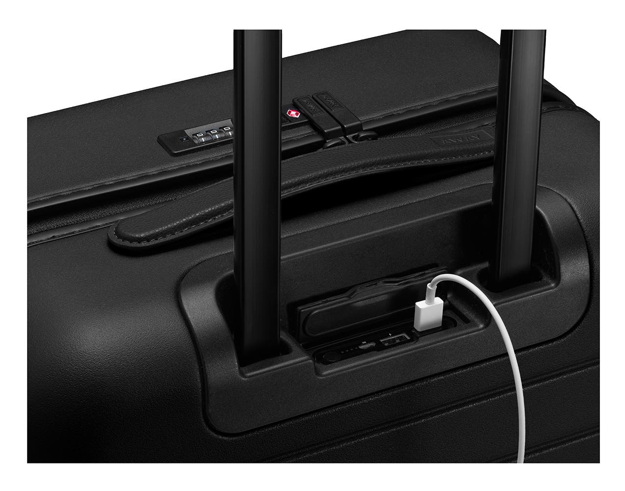 The Bigger Carry-On with Pocket in Black with charging cord plugged into battery underneath the telescoping handle