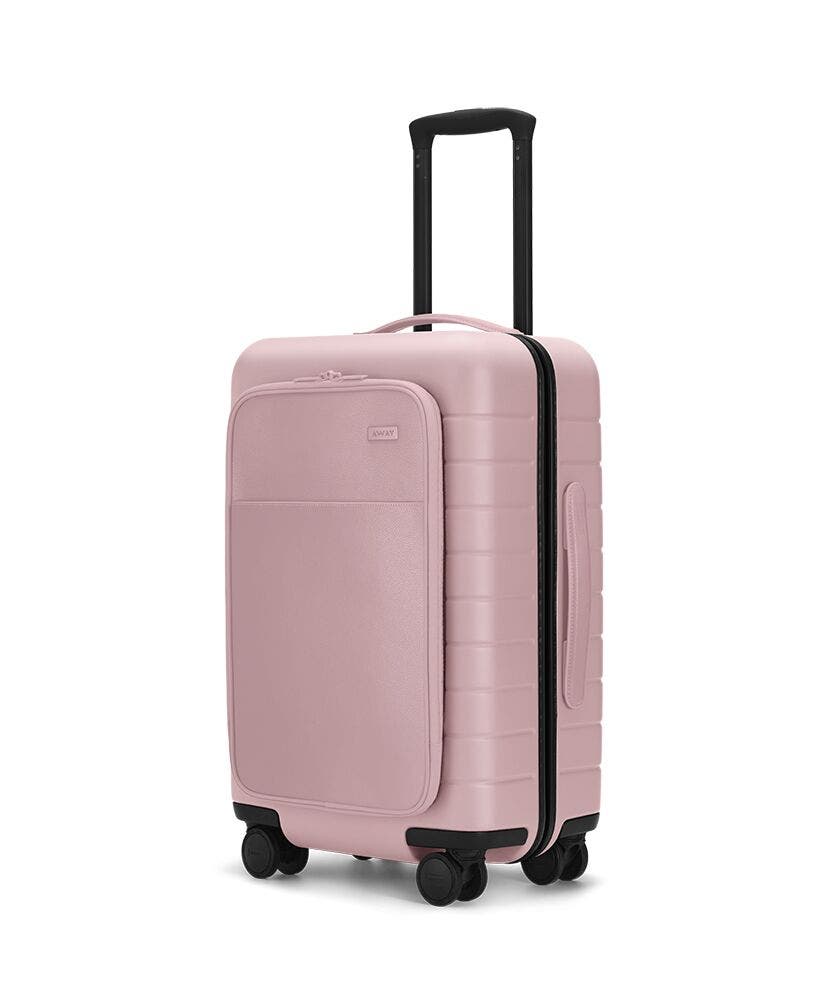 The Carry-On with Pocket in Blush shown at an angle with raised telescoping handle