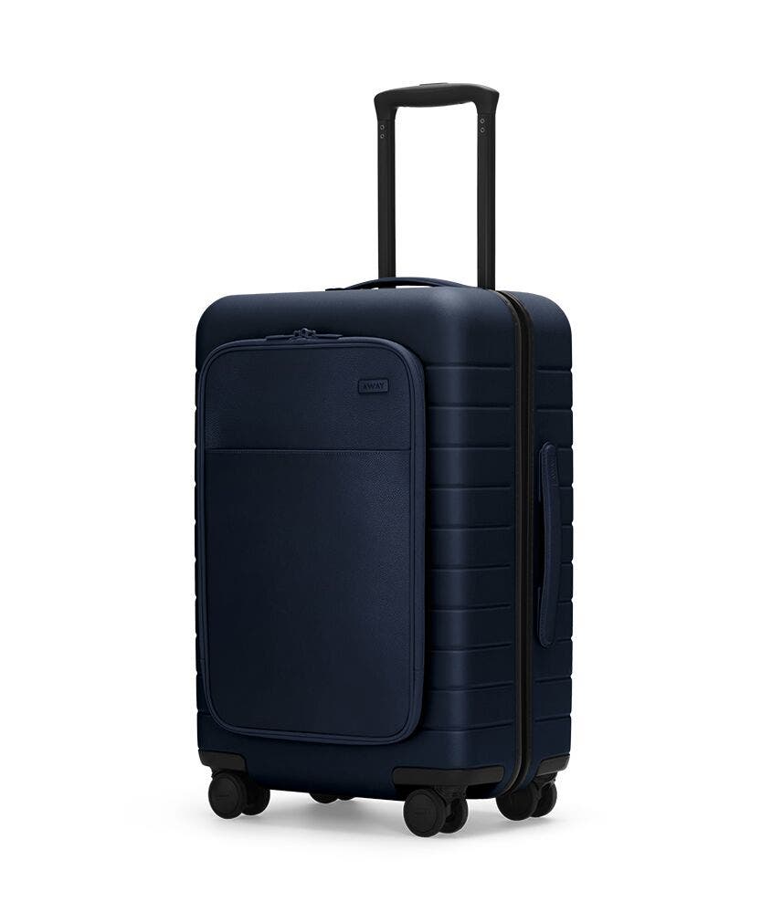 The Bigger Carry-On with Pocket in Navy shown at an angle with raised telescoping handle