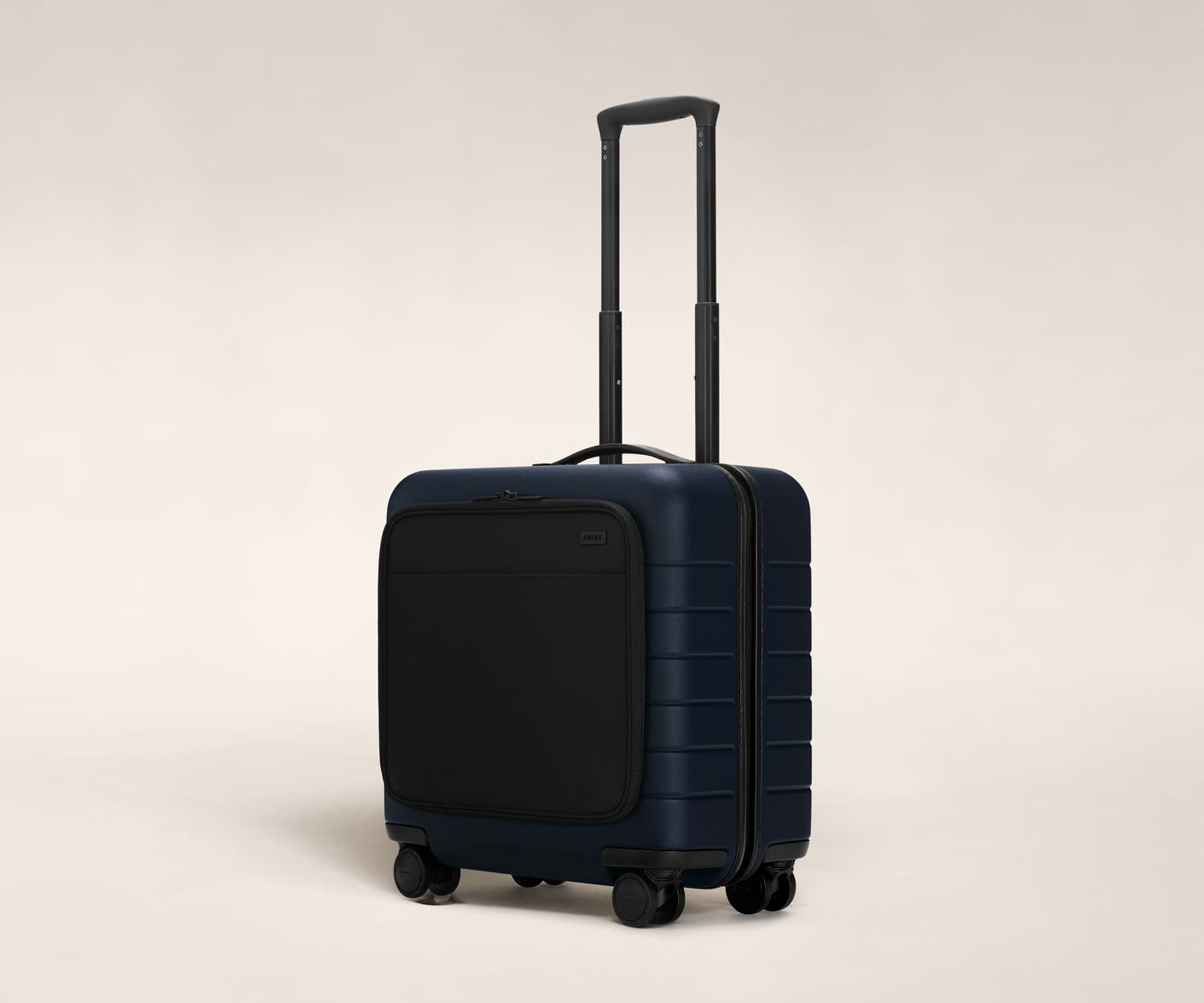 The Daily Carry-On with Pocket in Navy shown at an angle with raised telescoping handle